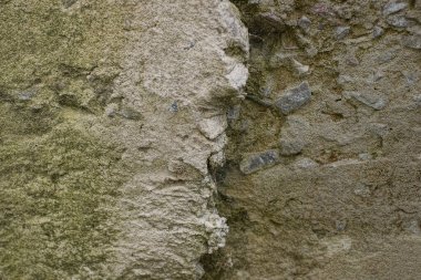 gray stone texture with a crack on dirty concrete wall
