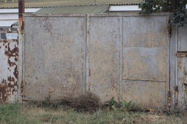 one closed rural metal gate on the fence wall in the street