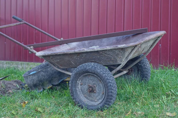 One Gray Old Metal Garden Wheelbarrow Black Wheels Stands Green — Stock Photo, Image