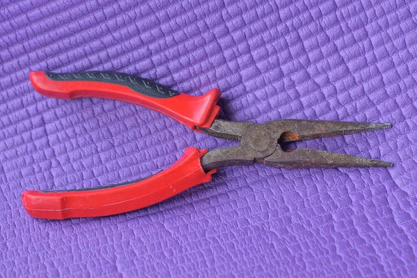 One Brown Rusty Iron Old Pliers Red Plastic Handles Lies — Stock Photo, Image