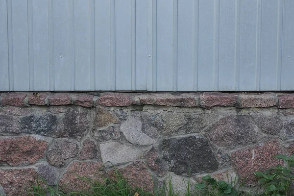 Egy Szürke Kerítésfal Egy Részének Textúrája Barna Kőalapon Zöld Füvön — Stock Fotó