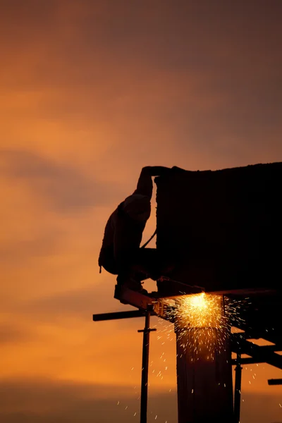 Silhouettes of worker welder — Stock Photo, Image