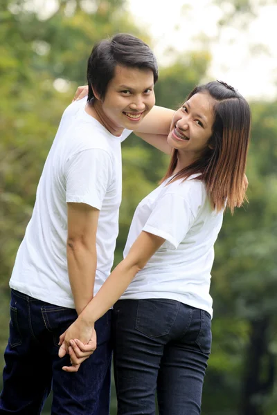 Young couple holding hands — Stock Photo, Image