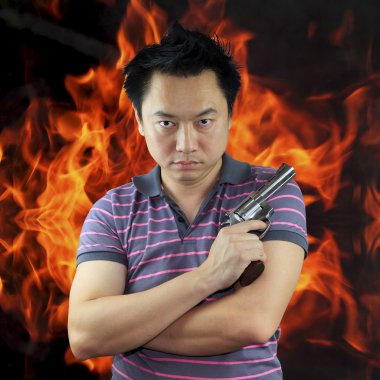 Man holding gun with fire background clipart