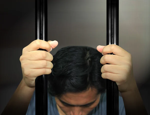 Man Hands of the prisoner on a steel lattice — Stock Photo, Image