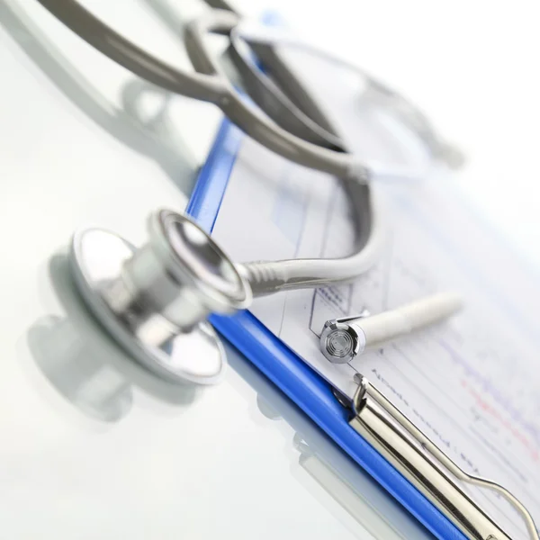 Stethoscope with blue medical clipboard — Stock Photo, Image
