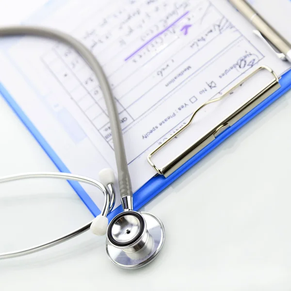 Stethoscope with blue medical clipboard — Stock Photo, Image