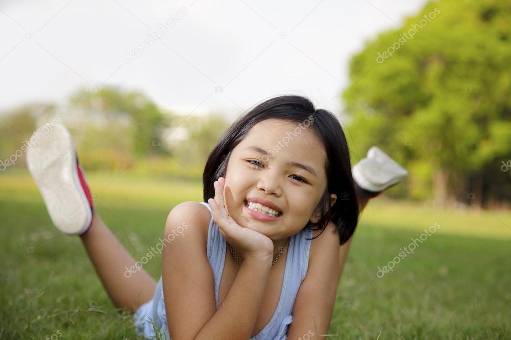 Asian little girl relax and smiling happily in the park