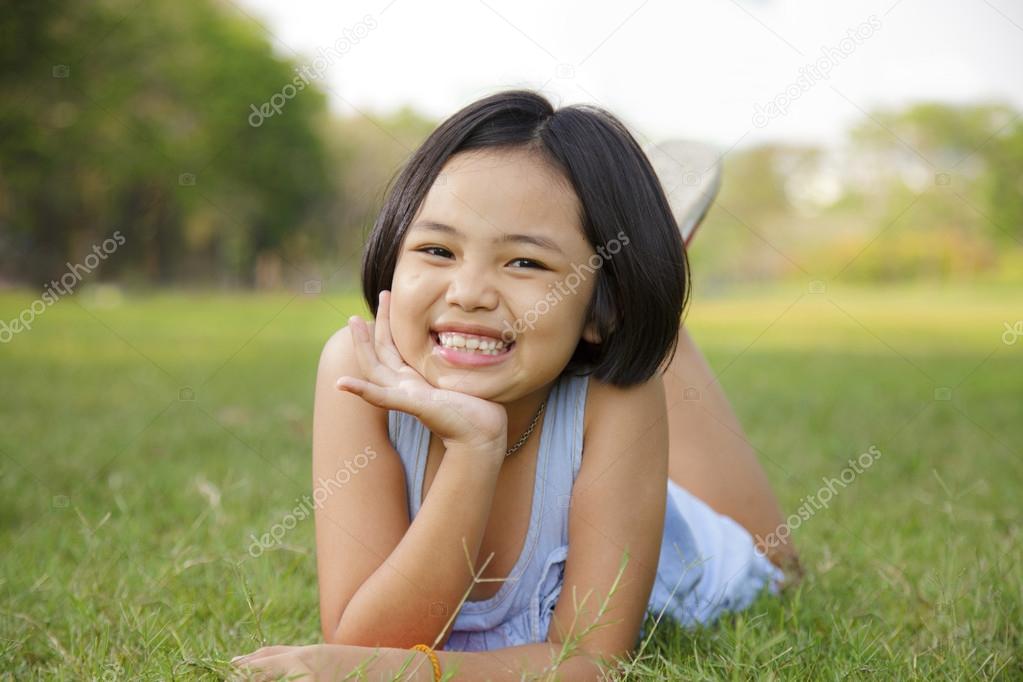 Asian little girl relax and smiling happily in the park