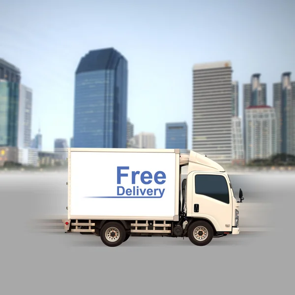 White van with Free delivery and office buildings in the city — Stock Photo, Image
