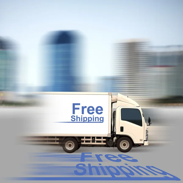 White van with Free Shipping and office buildings in the city — Stock Photo, Image