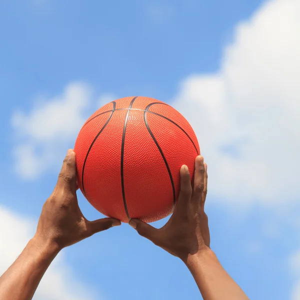 Basketball in hands — Stock Photo, Image