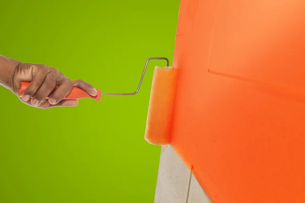 Orange color painting wall with roller — Stock Photo, Image