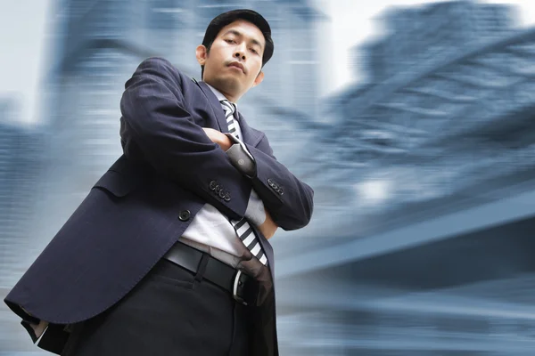 Businessman standing with modern office background — Stock Photo, Image