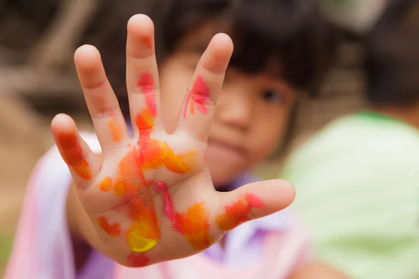 Little girl with hands painted in colorful paint — Stock Photo, Image