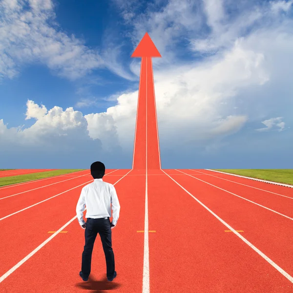 Businessman standing on running track — Stock Photo, Image