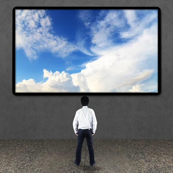 Businessman looking at TV screen — Stock Photo, Image