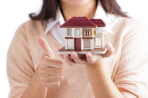 Woman holding little house — Stock Photo, Image