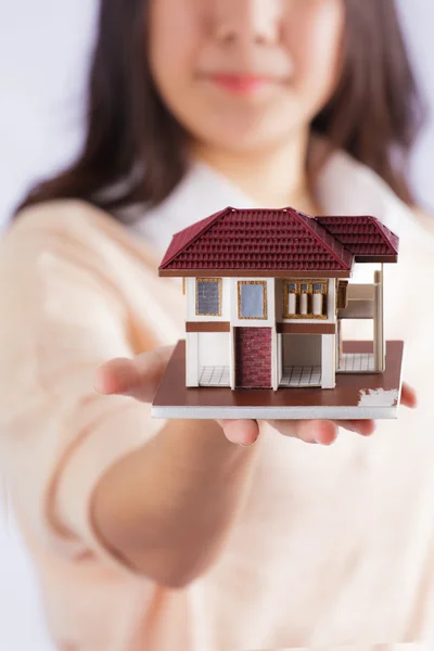 Woman holding little house — Stock Photo, Image