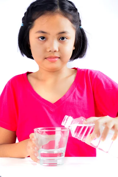 Little girl pours water — Stock Photo, Image