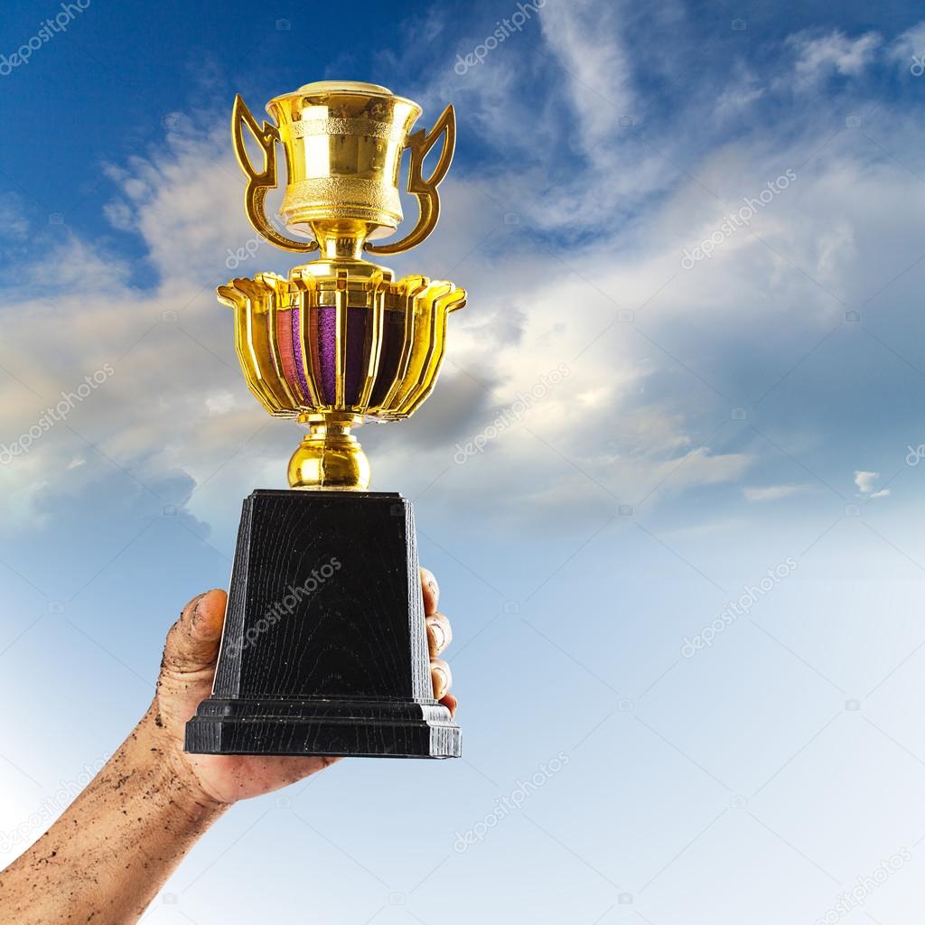 Hand holding trophy — Stock Photo © Naypong #44498261
