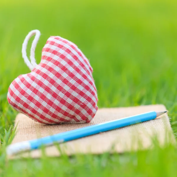 Fabric heart on diary — Stock Photo, Image