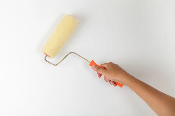 Hand holding paint roller — Stock Photo, Image