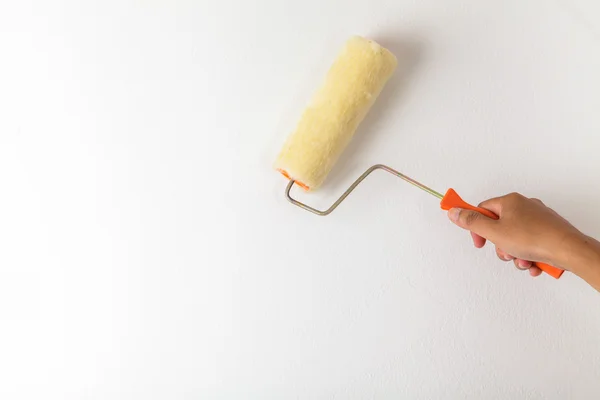 Hand holding paint roller — Stock Photo, Image