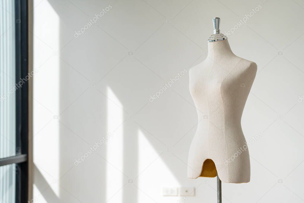 Textile mannequin in showroom with sunlight in the background