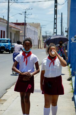 Cienfuegos, Küba, Mayıs 2022: Geleneksel okul üniformalı iki genç kız