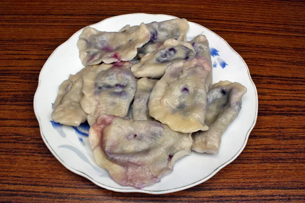 Dumplings with blueberries on a plate — Stock Photo, Image