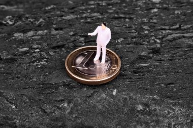 Miniature figure businessman on euro clipart