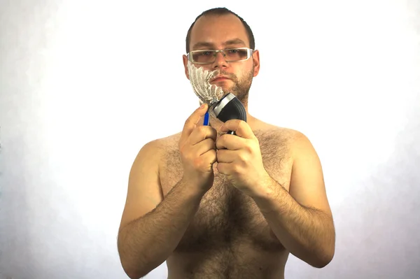 Man with electric shaver