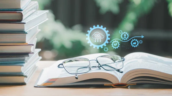 A simple composition of many books, stack or pile of books on wooden table, one of them open and glasses with icons save CO2 and energy sources for renewable concept.