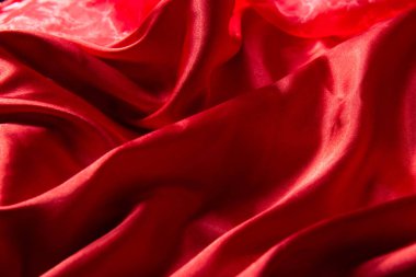 Güzel kırmızı ipek arka plan. Kumaşın, dokunun örtülü arkaplanı. Uzayı kopyala Kapat.