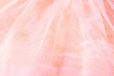 Beautiful nude pink tulle with shiny beads background. Draped background of pink powdery fabric, texture