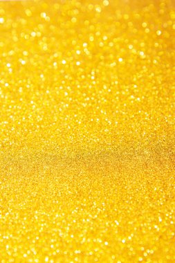 Altın modaya uygun bir zemin. Işıklardan yapılmış ışıltılı bir arka plan. Neşeli bulanık arkaplan