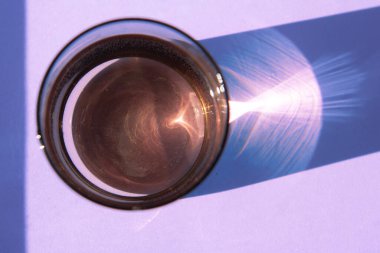 Glass of fresh water on blue background with copy space