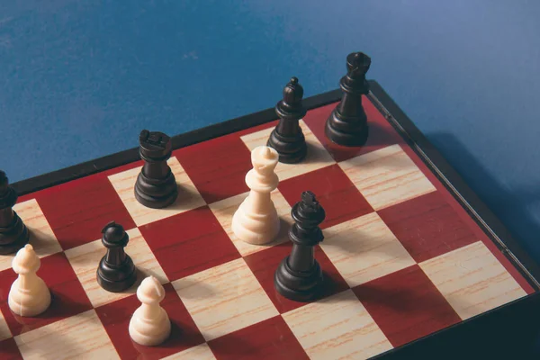 Chess pieces on the board. Chess game. White and black chess figures for the game and strategy. Colorful chess concept