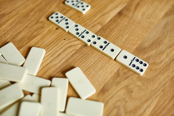 Top view of white domino games on wooden table background with copy space, board game concept