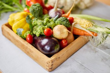 Wooden box with different fresh farm vegetables on the white background, Autumn harvest and healthy organic bio food concept, Garden produce and harvested vegetable