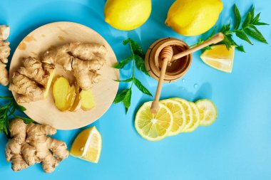 Immune boosting remedy, immunity boosting foods ginger, lemon,  honey,  mint on blue background, Flat lay Top view, copy spac