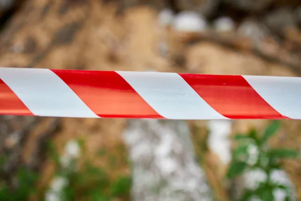 Red and white barrier warning tape, sign area for safety, Dry chopped, sawn wooden logs wooden pole texture