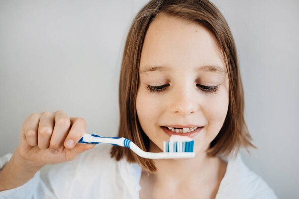 Girl brushes her teeth, dental care since childhood, a visit to the dentist