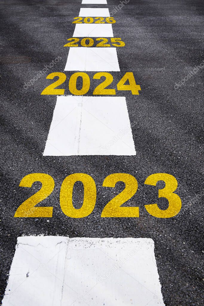 2023 Future opportunity concept and economic recovery idea. Next word written on asphalt road with white marking lines.
