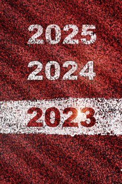 2023, 2024 and 2025 written on red sport track with starting line. Future ahead challenge concept and planning idea