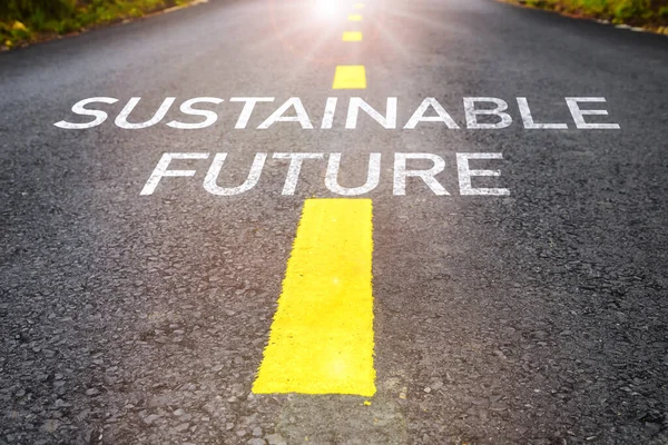 Sustainable future word on asphalt road surface with marking lines. Inspiration and motivation concept and effort idea