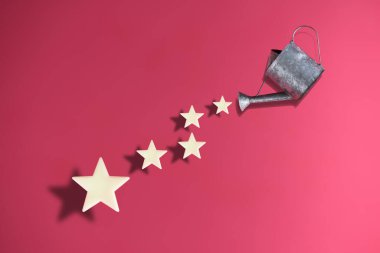 Watering the growing stars. Five stars feedback concept and business success idea