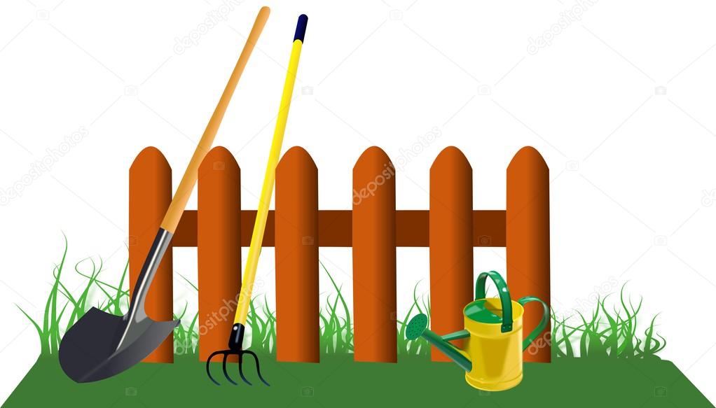 Fence in grass with garden tools