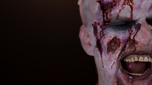 Față înfricoșătoare de om cu machiaj sângeros rănit de Halloween, fluxuri de sânge și picături pe față — Videoclip de stoc